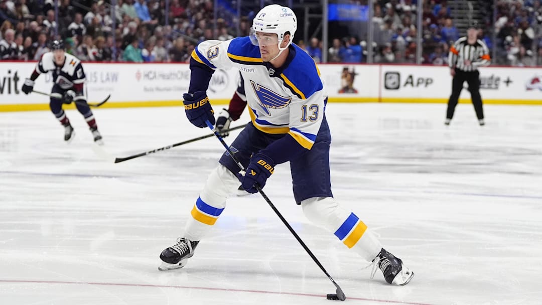 Mar 29, 2025; Denver, Colorado, USA; St. Louis Blues right wing Alexey Toropchenko (13) prepares to shoot the puck in the first period against the Colorado Avalanche at Ball Arena. Mandatory Credit: Ron Chenoy-Imagn Images