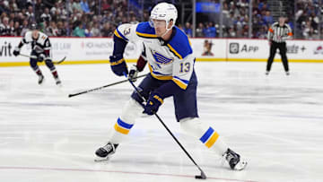 Mar 29, 2025; Denver, Colorado, USA; St. Louis Blues right wing Alexey Toropchenko (13) prepares to shoot the puck in the first period against the Colorado Avalanche at Ball Arena. Mandatory Credit: Ron Chenoy-Imagn Images