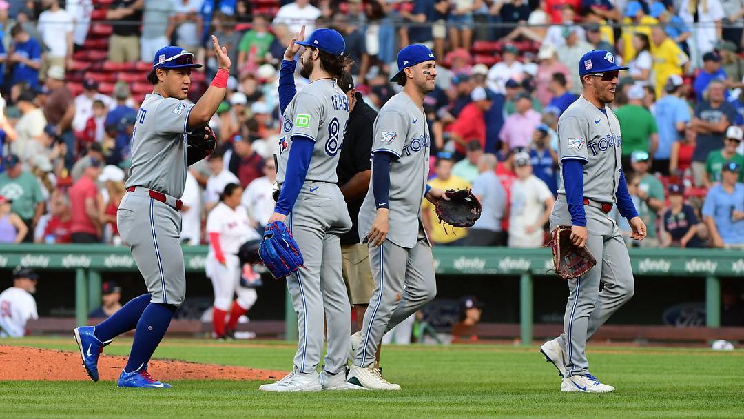 Toronto Blue Jays pitcher Dylan Cease high-fives his teammates after defeating the Boston Red Sox. Toronto Blue Jays pitcher Dylan Cease high-fives his teammates after defeating the Boston Red Sox.