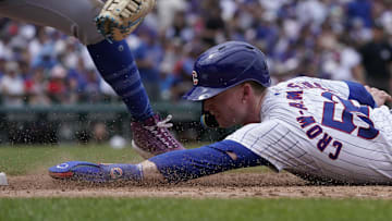 Jun 22, 2024; Chicago, Illinois, USA; Chicago Cubs outfielder Pete Crow-Armstrong (52) dives safely into first base as New York Mets first base Pete Alonso (20) makes a late tag during the sixth inning at Wrigley Field. Mandatory Credit: David Banks-USA TODAY Sports
