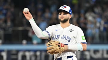 Oct 24, 2025; Toronto, Ontario, CAN; Toronto Blue Jays second baseman Bo Bichette (11) makes a play to get out Los Angeles Dodgers first baseman Freddie Freeman (not pictured) in the first inning during game one of the 2025 MLB World Series at Rogers Centre. Mandatory Credit: Dan Hamilton-Imagn Images