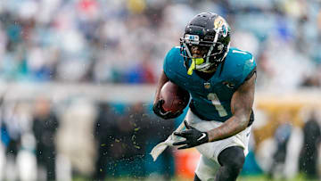 Dec 29, 2024; Jacksonville, Florida, USA; Jacksonville Jaguars running back Travis Etienne Jr. (1) runs the ball against the Tennessee Titans during the second quarter at EverBank Stadium. Mandatory Credit: Morgan Tencza-Imagn Images