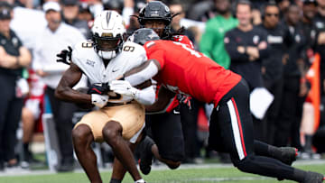 UCF Knights wide receiver DJ Black (9) is tackled by Cincinnati Bearcats wide receiver Giyahni Kontosis (17) in the first quarter of the NCAA football game between the Cincinnati Bearcats and UCF Knights at Nippert Stadium in Cincinnati on Oct. 11, 2025.