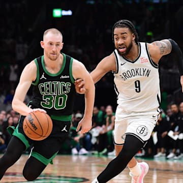 Mar 18, 2025; Boston, Massachusetts, USA; Boston Celtics forward Sam Hauser (30) controls the ball while Brooklyn Nets forward Trendon Watford (9) defends during the second half at TD Garden. Mandatory Credit: Bob DeChiara-Imagn Images