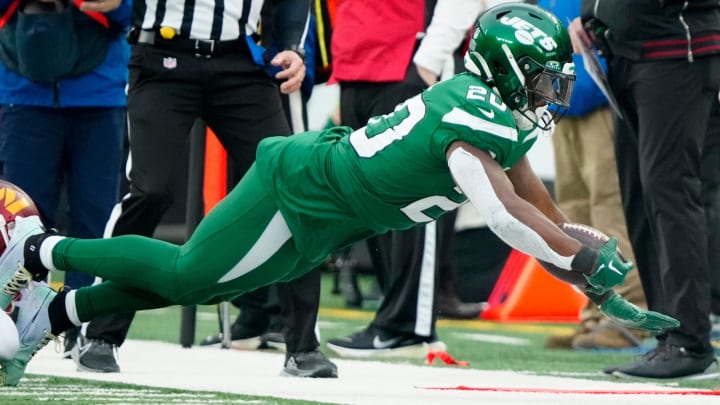 New York Jets running back Breece Hall (20) leaps for the first down, at MetLife Stadium, Sunday December 24, 2023.