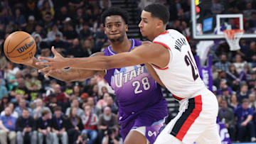 Feb 24, 2025; Salt Lake City, Utah, USA; Utah Jazz forward Brice Sensabaugh (28) passes against Portland Trail Blazers forward Kris Murray (24) during the first half at Delta Center. Mandatory Credit: Rob Gray-Imagn Images