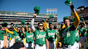 Sep 26, 2024; Oakland, California, USA; Oakland Athletics players tip their caps to the crowd after the game against the Texas Rangers at Oakland-Alameda County Coliseum. Mandatory Credit: Ed Szczepanski-Imagn Images