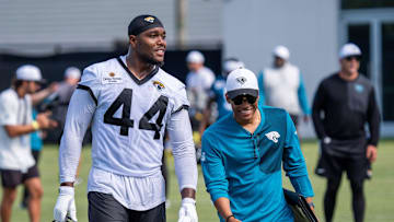 Jacksonville Jaguars defensive end Travon Walker (44) and Jacksonville Jaguars Senior Director of Football Communications Dylan Morton have a laugh during an NFL training camp second session at the Miller Electric Center, Thursday, July 24, 2025.
