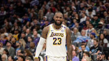 Los Angeles Lakers forward LeBron James smiles after his team scored against the Sacramento Kings.