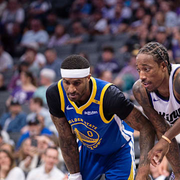 Oct 9, 2024; Sacramento, California, USA; Golden State Warriors guard Gary Payton II (0) and forward Jonathan Kuminga (00) defend against Sacramento Kings forward DeMar DeRozan (10) during a free throw attempt in the second quarter at Golden 1 Center. Mandatory Credit: Ed Szczepanski-Imagn Images