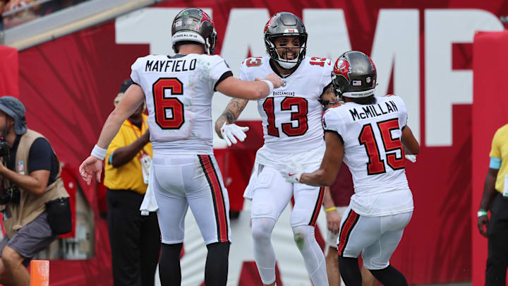 Tampa Bay Buccaneers wide receiver Mike Evans (13)  is congratulated by quarterback Baker Mayfield (6) and wide receiver Jalen McMillan.