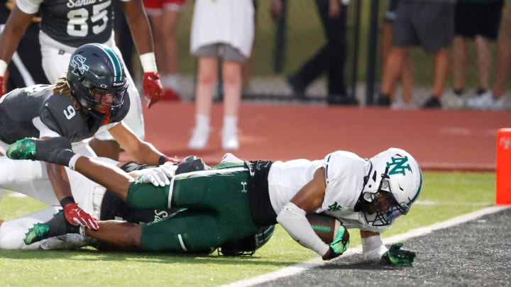 Norman North's Mason James scores a touchdown in front of Edmond Santa Fe's Franklin Sherrod during a high school football game between Edmond Santa Fe and Norman North in Edmond, Okla., Friday, Sept. 8, 2023.