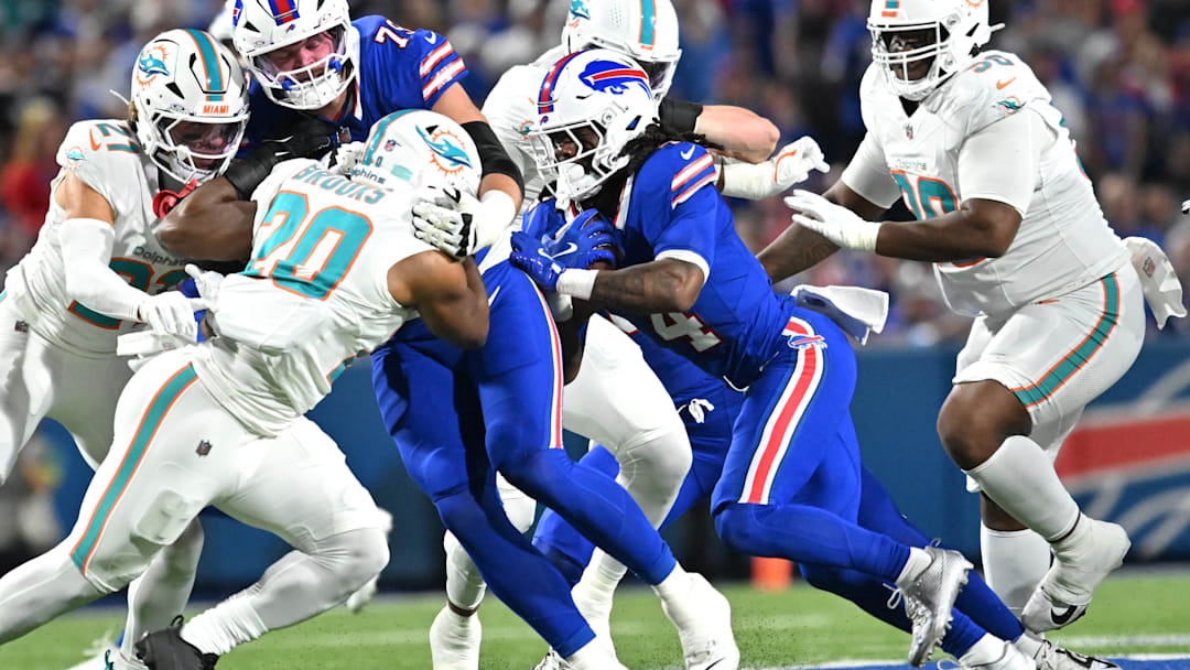 Sep 18, 2025; Orchard Park, New York, USA; Buffalo Bills running back James Cook (4) runs against the Miami Dolphins in the first quarte at Highmark Stadium. Mandatory Credit: Mark Konezny-Imagn Images
