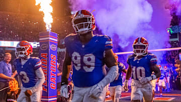 Florida Gators defensive lineman Cam Jackson (99) runs out of the tunnel with the team as fireworks and fire shoot out of towers before the start of the game at Ben Hill Griffin Stadium in Gainesville, FL on Saturday, October 5, 2024. [Doug Engle/Gainesville Sun]