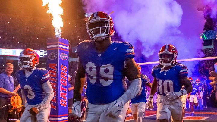 Florida Gators defensive lineman Cam Jackson (99) runs out of the tunnel with the team as fireworks and fire shoot out of towers before the start of the game at Ben Hill Griffin Stadium in Gainesville, FL on Saturday, October 5, 2024. [Doug Engle/Gainesville Sun]