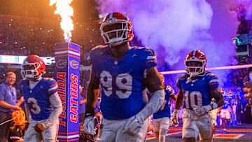 Florida Gators defensive lineman Cam Jackson (99) runs out of the tunnel with the team as fireworks and fire shoot out of towers before the start of the game at Ben Hill Griffin Stadium in Gainesville, FL on Saturday, October 5, 2024. [Doug Engle/Gainesville Sun]