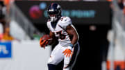 Sep 17, 2023; Denver, Colorado, USA; Denver Broncos running back Javonte Williams (33) runs the ball in the second quarter against the Washington Commanders at Empower Field at Mile High. 