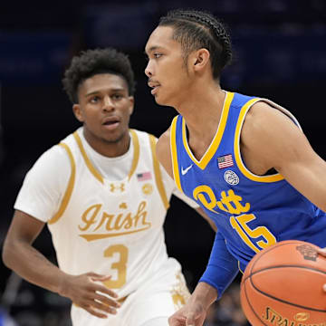 Mar 11, 2025; Charlotte, NC, USA; Pittsburgh Panthers guard Jaland Lowe (15) goes to the basket against Notre Dame Fighting Irish guard Markus Burton (3) during the first half at Spectrum Center. Mandatory Credit: Jim Dedmon-Imagn Images