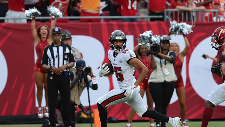 Sep 8, 2024; Tampa, Florida, USA; Tampa Bay Buccaneers wide receiver Jalen McMillan (15) scores a touchdown  against the Washington Commanders during the second half at Raymond James Stadium. Mandatory Credit: Kim Klement Neitzel-Imagn Images