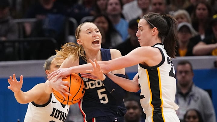 Iowa Hawkeyes guard Caitlin Clark (22) is called for a foul on UConn Huskies guard Paige Bueckers (5) during the Final Four round of the NCAA Women's Basketball Tournament between Iowa and UConn at Rocket Mortgage Fieldhouse, Friday, April 5, 2024 in Cleveland.