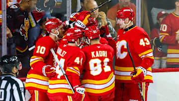 Apr 13, 2025; Calgary, Alberta, CAN; Calgary Flames defenseman MacKenzie Weegar (52) celebrates his goal with teammates against the San Jose Sharks during the first period at Scotiabank Saddledome. Mandatory Credit: Sergei Belski-Imagn Images
