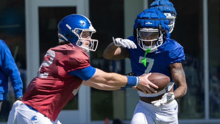 University of Kentucky quarterback Brock Vandagriff hands the ball off to wide receiver Barion Brown during spring football practice on Saturday, April 6, 2024.