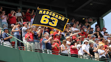 June 19, 2011; Boston, MA, USA; A Boston Red Sox employee waves a Brad Marchand (not pictured) flag as part of a pre-game ceremony to honor the 2011 Stanley Cup Champion Boston Bruins at Fenway Park. Mandatory Credit: Bob DeChiara-Imagn Images