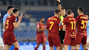 Referee Davide Massa shows a red card to Roger Ibanez of AS...