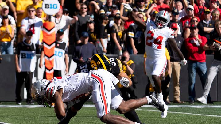 Iowa Hawkeyes linebacker Jayden Montgomery (36) tackles Ohio State Buckeyes wide receiver Devin McCuin (3) as he scores a touchown Oct. 3, 2026 at Kinnick Stadium in Iowa City, Iowa.