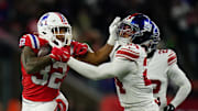 Dec 1, 2025; Foxborough, Massachusetts, USA; New England Patriots running back TreVeyon Henderson (32) runs the ball against New York Giants safety Dane Belton (24) during the fourth quarter at Gillette Stadium.  