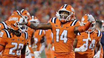 Sep 7, 2024; Champaign, Illinois, USA; Illinois Fighting Illini cornerback Xavier Scott (14) celebrates his team’s lead over the Kansas Jayhawks during the first half at Memorial Stadium. Mandatory Credit: Ron Johnson-Imagn Images