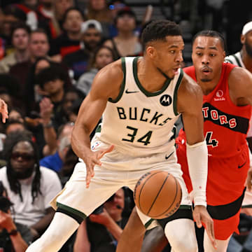 Oct 24, 2025; Toronto, Ontario, CAN; Milwaukee Bucks forward Giannis Antetokounmpo (34) is defended by Toronto Raptors forward Scottie Barnes (4) in the fourth quarter at Scotiabank Arena. Mandatory Credit: Gerry Angus-Imagn Images