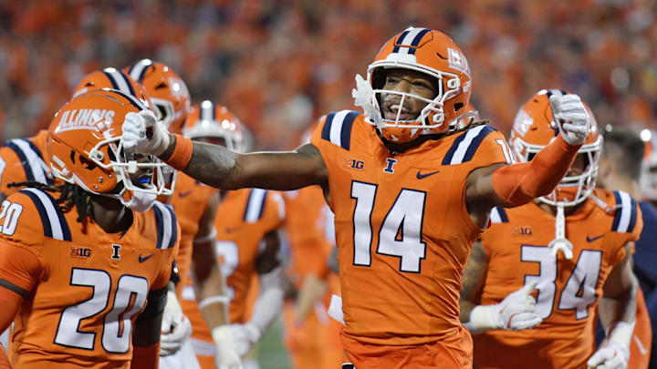 Sep 7, 2024; Champaign, Illinois, USA; Illinois Fighting Illini cornerback Xavier Scott (14) celebrates his team’s lead over the Kansas Jayhawks during the first half at Memorial Stadium. Mandatory Credit: Ron Johnson-Imagn Images