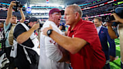 Sep 28, 2024; Arlington, Texas, USA; Texas A&M Aggies head coach Mike Elko (left) shakes hands with Arkansas Razorbacks head coach Sam Pittman (right) after the game  at AT&T Stadium.