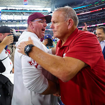 Sep 28, 2024; Arlington, Texas, USA; Texas A&M Aggies head coach Mike Elko (left) shakes hands with Arkansas Razorbacks head coach Sam Pittman (right) after the game  at AT&T Stadium.