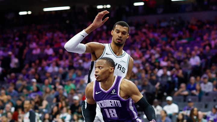 Mar 17, 2026; Sacramento, California, USA; Sacramento Kings guard Russell Westbrook (18) dribbles around San Antonio Spurs forward Victor Wembanyama (1) during the third quarter at Golden 1 Center. Mandatory Credit: Sergio Estrada-Imagn Images