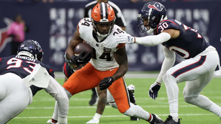 Dec 24, 2023; Houston, Texas, USA; Cleveland Browns running back Jerome Ford (34) rushes against Houston Texans safety DeAndre Houston-Carson (30) in the second half at NRG Stadium. Mandatory Credit: Thomas Shea-USA TODAY Sports