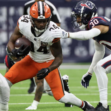 Dec 24, 2023; Houston, Texas, USA; Cleveland Browns running back Jerome Ford (34) rushes against Houston Texans safety DeAndre Houston-Carson (30) in the second half at NRG Stadium.