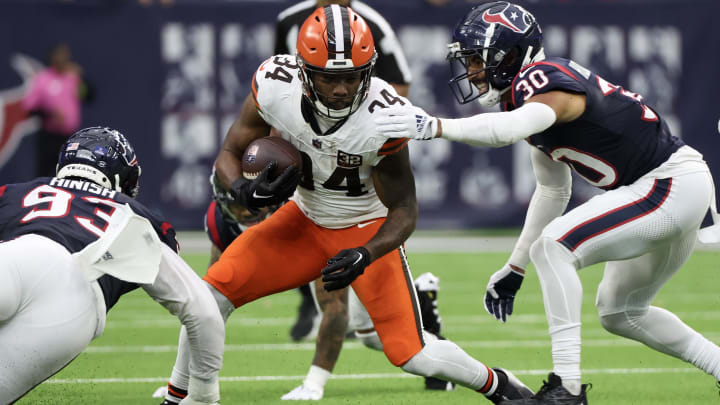 Dec 24, 2023; Houston, Texas, USA; Cleveland Browns running back Jerome Ford (34) rushes against Houston Texans safety DeAndre Houston-Carson (30) in the second half at NRG Stadium.