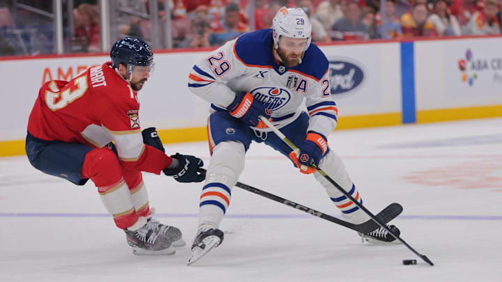 Jun 9, 2025; Sunrise, Florida, USA; Edmonton Oilers center Leon Draisaitl (29) controls the puck against Florida Panthers forward Sam Reinhart (13) during the first period in game three of the 2025 Stanley Cup Final at Amerant Bank Arena. Mandatory Credit: Sam Navarro-Imagn Images