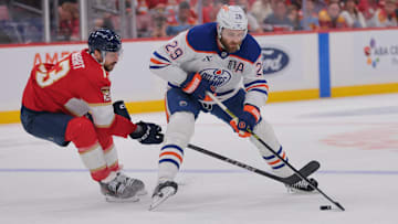 Jun 9, 2025; Sunrise, Florida, USA; Edmonton Oilers center Leon Draisaitl (29) controls the puck against Florida Panthers forward Sam Reinhart (13) during the first period in game three of the 2025 Stanley Cup Final at Amerant Bank Arena. Mandatory Credit: Sam Navarro-Imagn Images