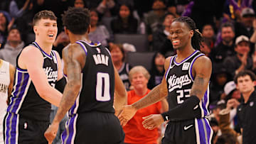 Feb 8, 2025; Sacramento, California, USA; Sacramento Kings forward Jake LaRavia (33), guard Malik Monk (0) and guard Keon Ellis (23) celebrate after a play against the New Orleans Pelicans during the fourth quarter at Golden 1 Center. Mandatory Credit: Kelley L Cox-Imagn Images
