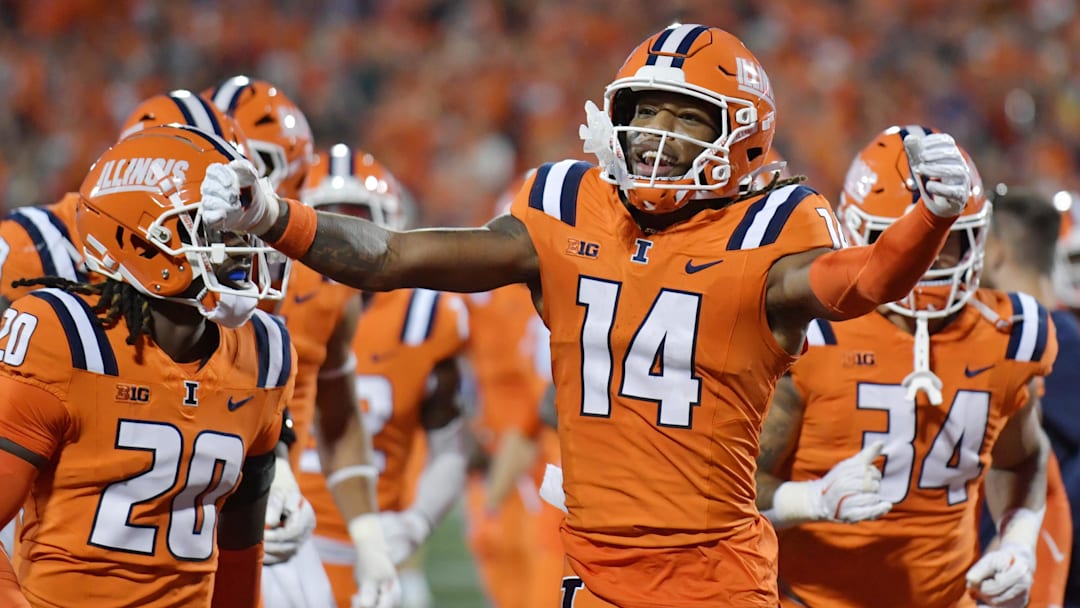 Sep 7, 2024; Champaign, Illinois, USA; Illinois Fighting Illini tight end Cole Rusk (14) celebrates his team’s lead over the Kansas Jayhawks during the first half at Memorial Stadium. Mandatory Credit: Ron Johnson-Imagn Images