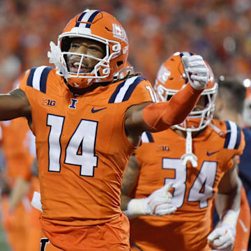 Sep 7, 2024; Champaign, Illinois, USA; Illinois Fighting Illini tight end Cole Rusk (14) celebrates his team’s lead over the Kansas Jayhawks during the first half at Memorial Stadium. Mandatory Credit: Ron Johnson-Imagn Images