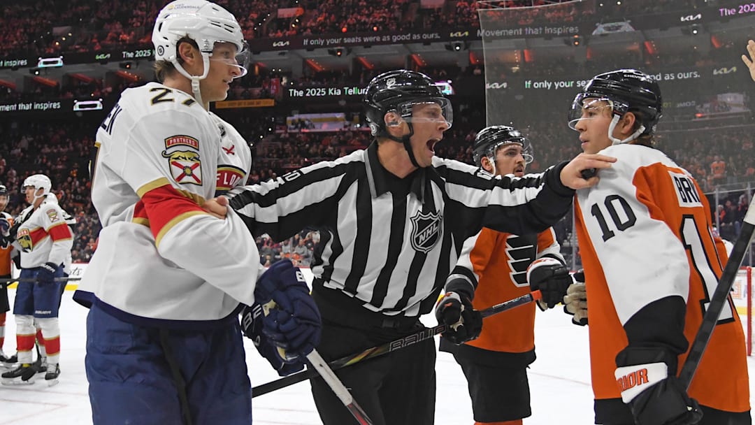 Dec 5, 2024; Philadelphia, Pennsylvania, USA; Linesman Libor Suchanek (60) separates Florida Panthers center Eetu Luostarinen (27) and Philadelphia Flyers right wing Bobby Brink (10) during the third period at Wells Fargo Center.