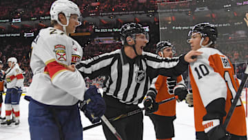 Dec 5, 2024; Philadelphia, Pennsylvania, USA; Linesman Libor Suchanek (60) separates Florida Panthers center Eetu Luostarinen (27) and Philadelphia Flyers right wing Bobby Brink (10) during the third period at Wells Fargo Center.