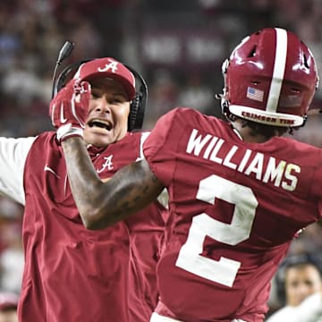 Sep 7, 2024; Tuscaloosa, Alabama, USA;  Alabama Crimson Tide wide receiver Ryan Williams (2) celebrates an assistant coach after scoring a touchdown agains the South Florida Bulls at Bryant-Denny Stadium. Alabama won 42-16. Mandatory Credit: Gary Cosby Jr.-Imagn Images