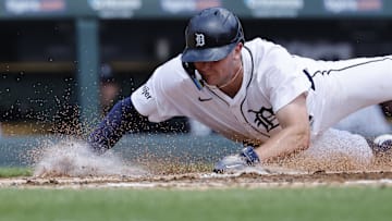 Detroit Tigers second baseman Trey Sweeney (27) dives in safe at home in the second inning against the Los Angeles Angels at Comerica Park.