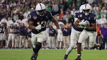 Penn State Nittany Lions running back Nicholas Singleton (10) runs the ball in for a touchdown behind lead blocker Kaytron Allen against Notre Dame in the Orange Bowl. 