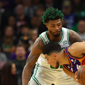 Dec 7, 2022; Phoenix, Arizona, USA; Boston Celtics guard Marcus Smart (36) against Phoenix Suns guard Devin Booker (1) at Footprint Center. Mandatory Credit: Mark J. Rebilas-Imagn Images